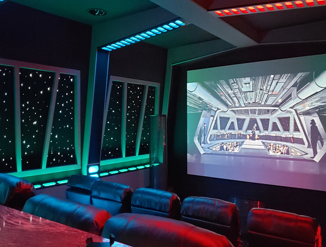 Star Command home movie theater with custom acoustic star panels on the wall. LED lighting on the ceiling.