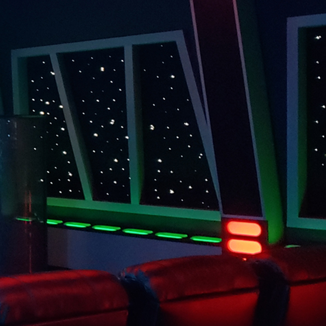 Star Wars dark home movie theater seating scene with star panels on the walls.