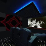 tv playing a black and white movie in a home theater with star ceiling and acoustic panels on the wall