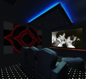 tv playing a black and white movie in a home theater with star ceiling and acoustic panels on the wall